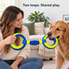 A dog and owner holding opposite rings of the blue and yellow tug toy during supervised play.